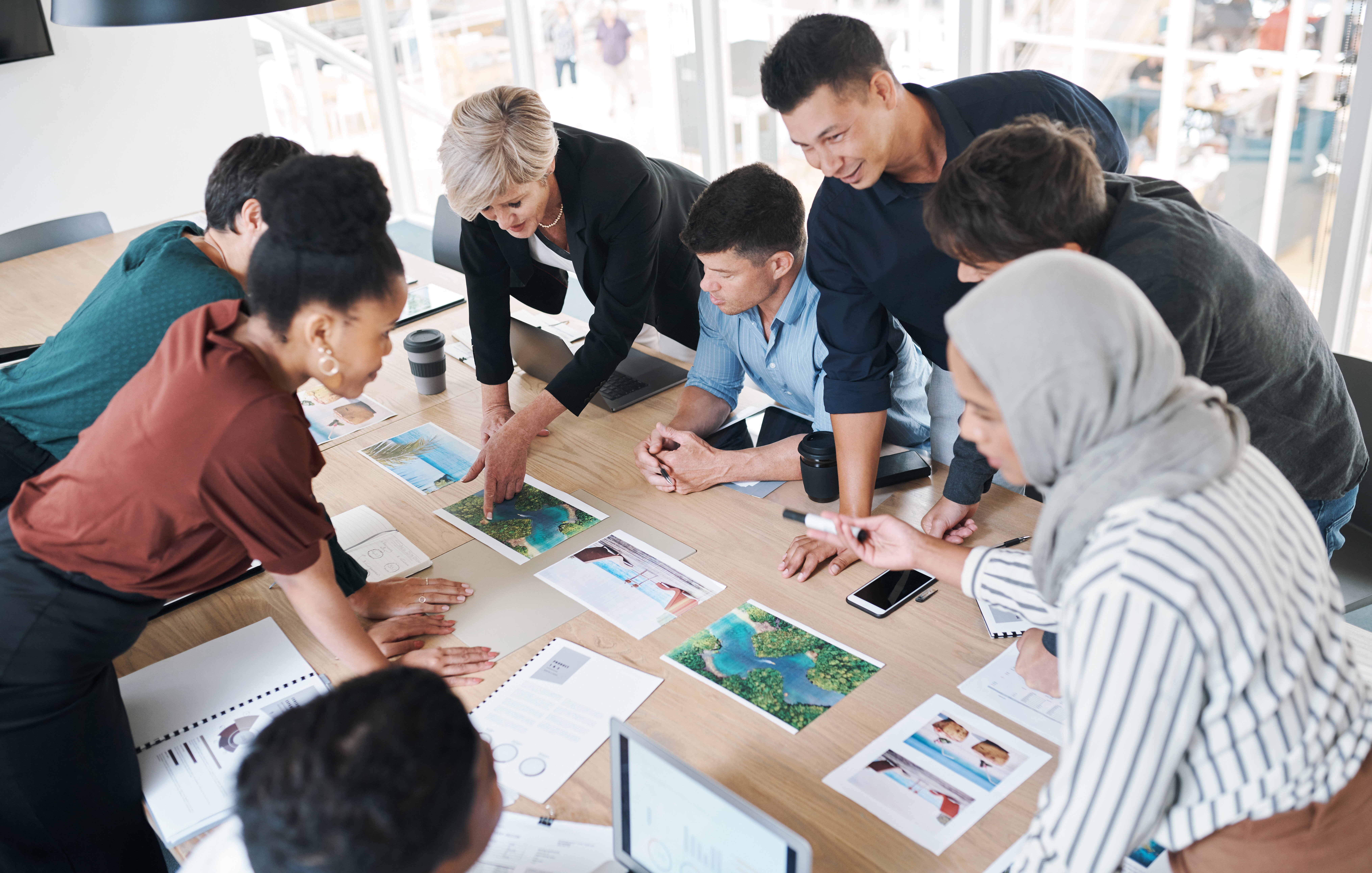 Team reviewing documents around a meeting table
